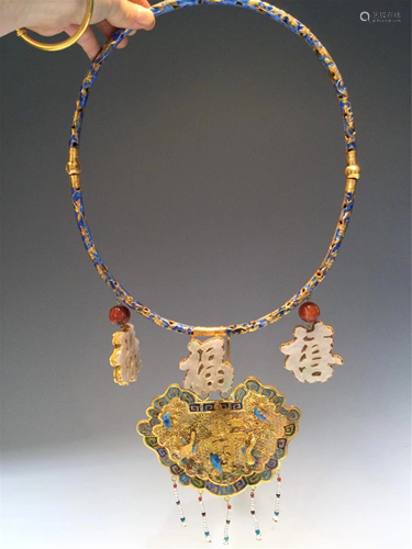 A POLYCHROME GILT SILVER NECKLACE DECORATION