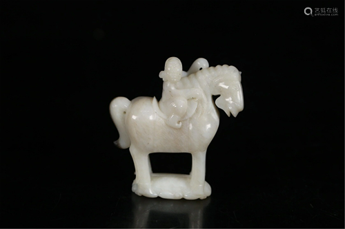 A JADE CARVING OF RIDING A HORSE