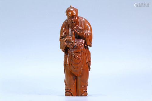 A CARVED HARDWOOD FIGURINE DECORATION