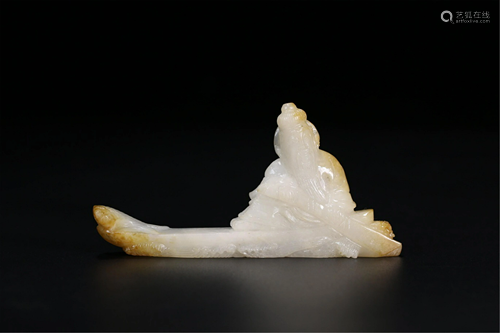 A JADE CARVING OF AND OLD MAN ROWING