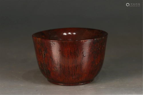 A CARVED BROWN CUP