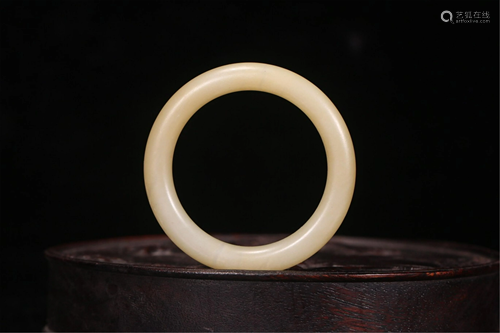 A CARVED JADE BANGLE