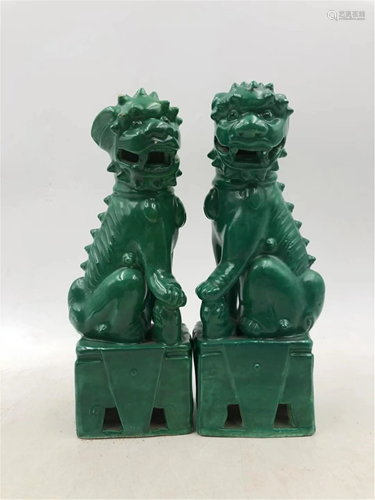 PAIR OF GREEN GLAZE PORCELAIN LIONS