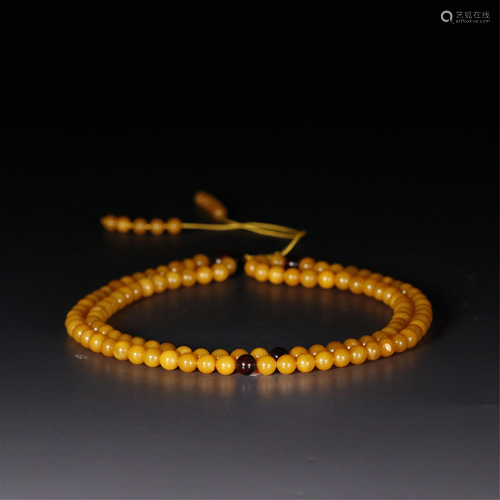 A STRING OF 108-BEAD CLOUDY AMBER PRAYER BEADS