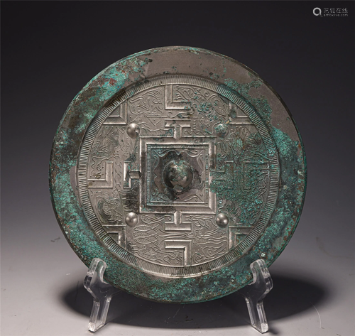 A BRONZE MIRROR WITH CARVINGS