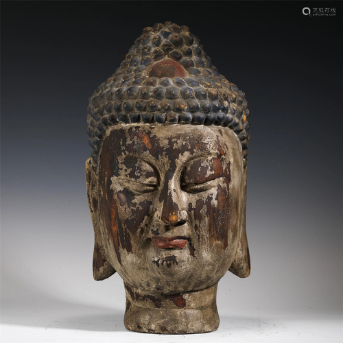 A WOODEN BUDDHA HEAD STATUETTE