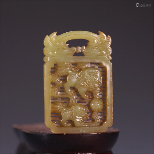 A CARVED YELLOW JADE BEAST PENDANT