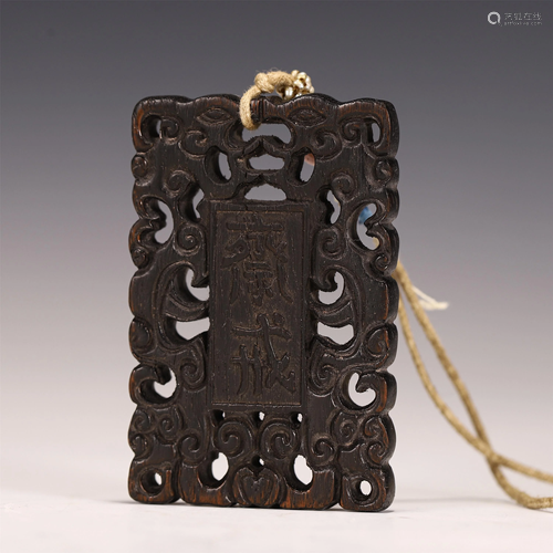 A CARVED CHENXIANG WOOD FASTING PENDANT