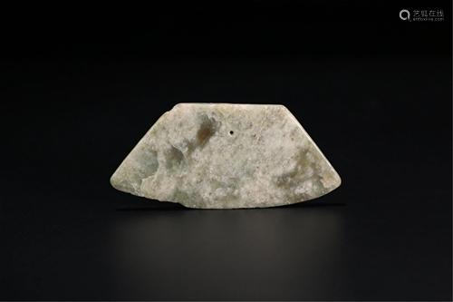 AN AXE SHAPED JADE PENDANT