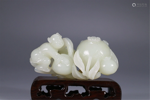 A JADE CARVING OF KID AND POMEGRANATE