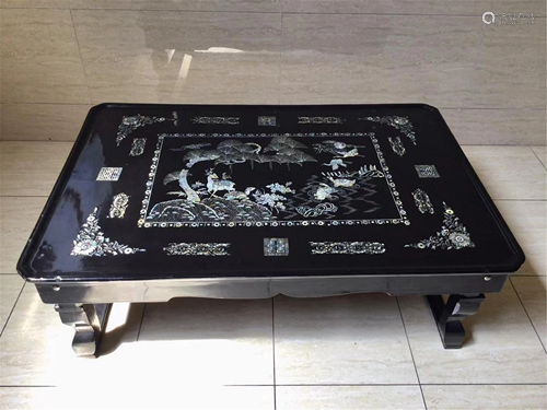 A MOTHER-OF-PEARL INLAID LACQUERED FOLDING TABLE