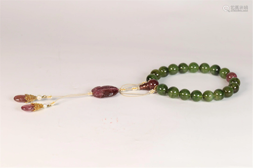 A STRING OF GREEN HARD-STONE PRAYER BEADS