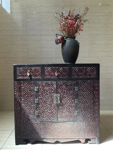 A CARVED LACQUER CABINET