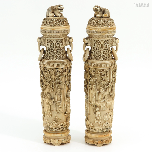 A Pair of Carved Vases with Covers