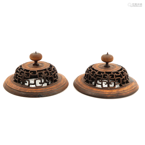 A Pair of Carved Wood Tops