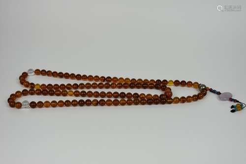 a string of chinese amber buddha's beads