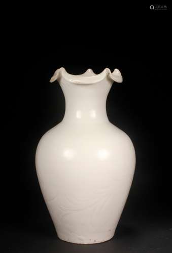 A Ding kiln carved flower mouth bottle