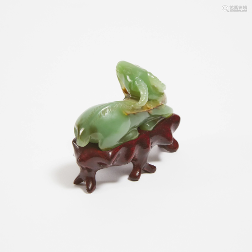 A Green and Russet Jade Carving of a Recumbent Ram,