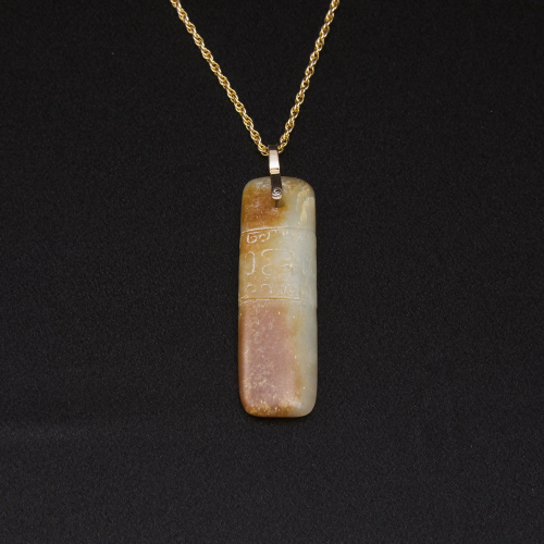 A White and Russet Jade Axe-Form Pendant, Ming Dynasty,