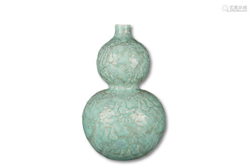 A Celadon Carved Gourd Procelain Bottle