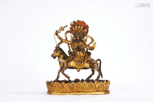A gilt-bronze statue of Dharma protector