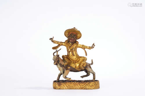 A gilt-bronze statue of Dharma protector