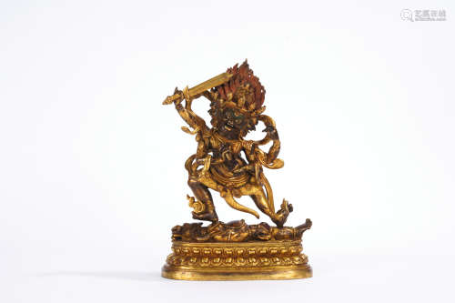 A gilt-bronze statue of Dharma protector