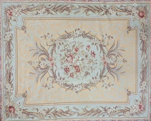 An Aubusson style embroidered rug with central floral