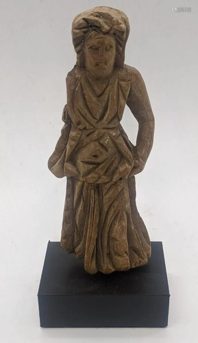 A Romano-Egyptian wood statuette of a woman wearing a