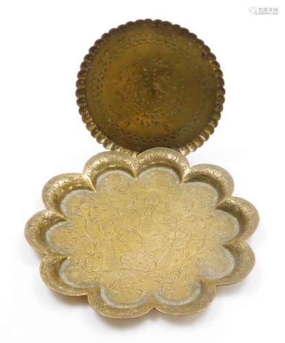 Two Eastern brass trays, to include a circular tray with cen...