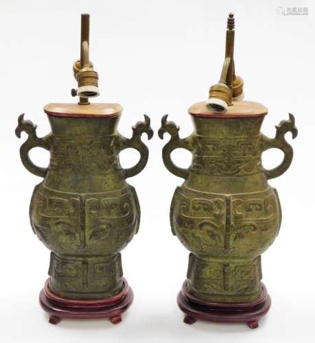 A pair of Eastern bronze twin sconce table lamps, each with ...
