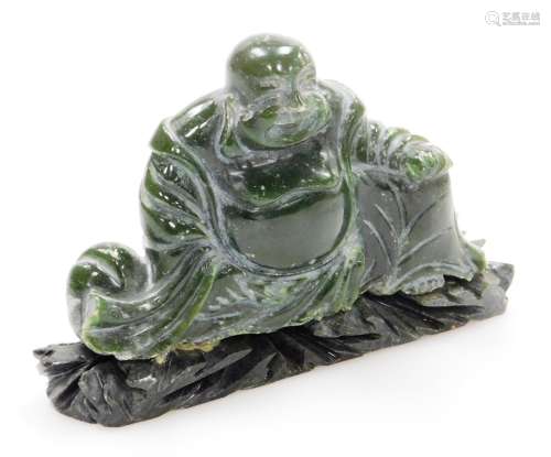 A Chinese carved green hardstone figure of a seated Putai, c...