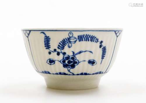 A Worcester tea bowl, on white finish with blue floral detai...