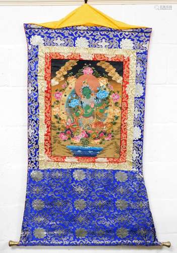 A Tibetan thangka depicting the green goddess, Mother Tara, ...