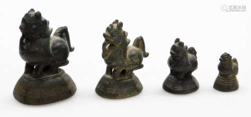 A set of four graduated Chinese bronze opium weights modelle...