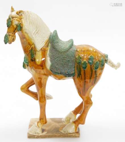A Chinese terracotta horse in Tang style, decorated in green...