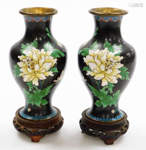 A pair of Chinese cloisonne baluster vases, on a black groun...