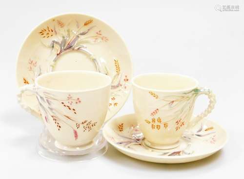 A pair of Belleek black mark first period coffee cup and sau...