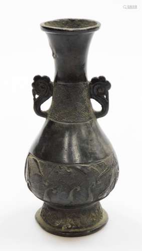 A Chinese bronze vase, on flared foot, with everted neck and...