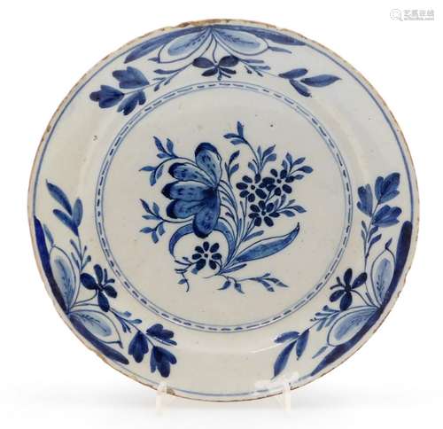 A late 18thC Dutch Delft blue and white charger, with flower...