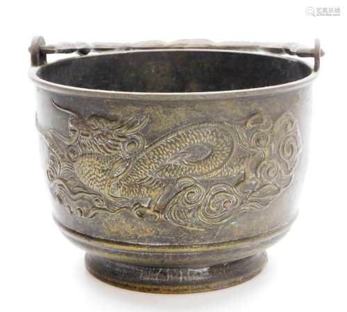 A Japanese bronze brazier with swing handle, low relief deco...