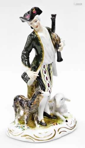 A German porcelain figure of a piper, 17cm high.