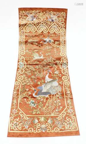 A Chinese embroidered silk panel, on a brown silk ground wit...