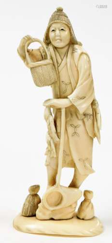 A Japanese carved ivory okimono of a fisherman carrying bask...