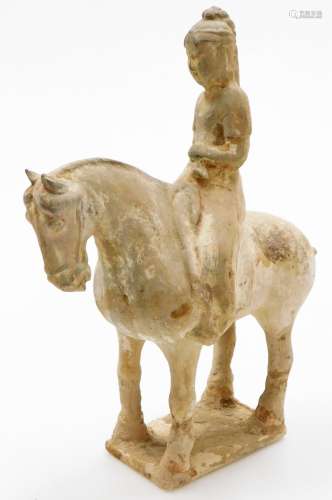 A Chinese Tang style pottery figure of a man on horseback, r...