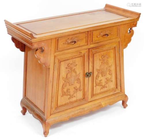 A Chinese hardwood cupboard, the inset top above two drawers...