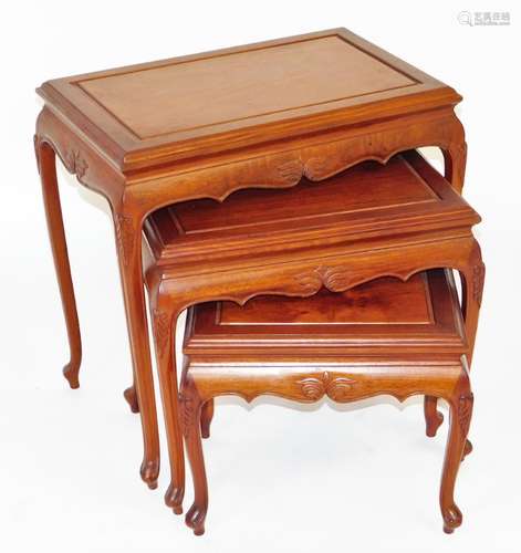 A nest of three Chinese hardwood tables, with splayed feet a...