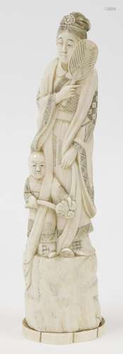 A Japanese marine ivory okimono of mother and child with fan...