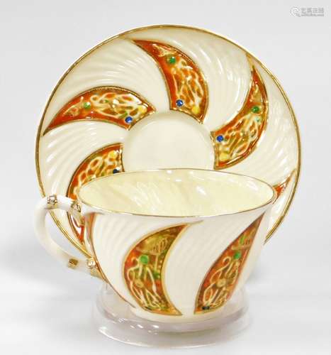 A rare decorated Celtic pattern Belleek cup and saucer, thir...