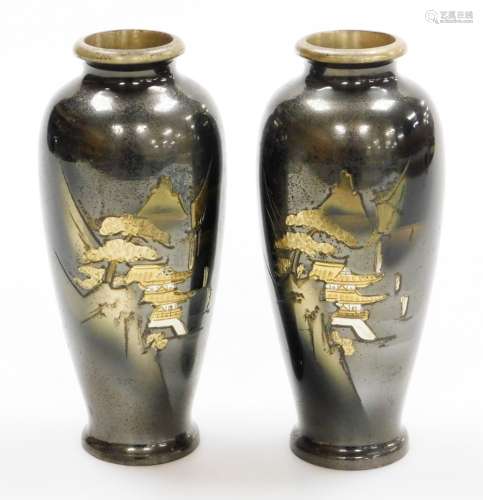 A pair of Japanese bronze vases, each with etched designs of...